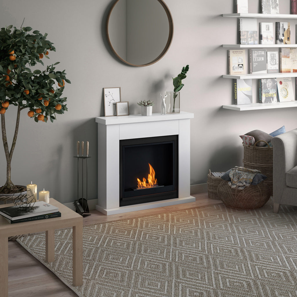 Living room with a fireplace, coffee table, and decorative items.
