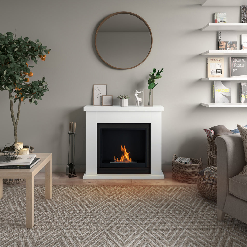 Living room with a white fireplace, round mirror, and decorative items.